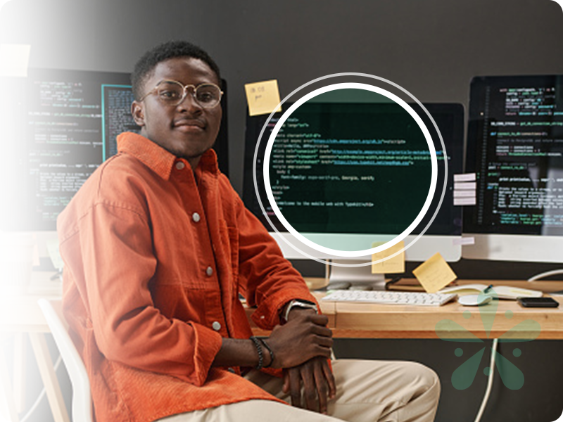 Developer sitting in front of multiple monitors
