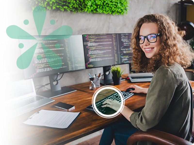 Female developer typing on a keyboard smiling